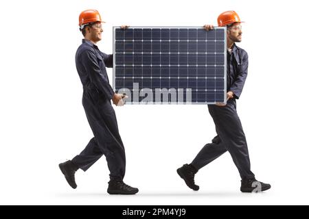 Factory workers carrying a solar panel and walking isolated on white background Stock Photo