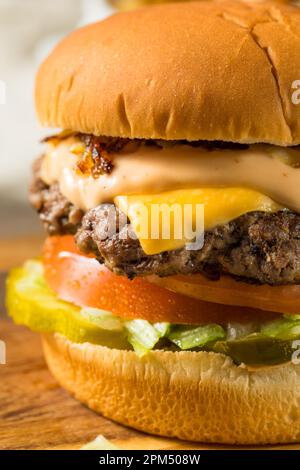 Fast Food Animal Cheeseburger with Burger Sauce and Pickles Stock Photo