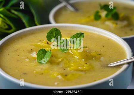 A bowl of leeks and potatoes soup. Above, close up. Stock Photo