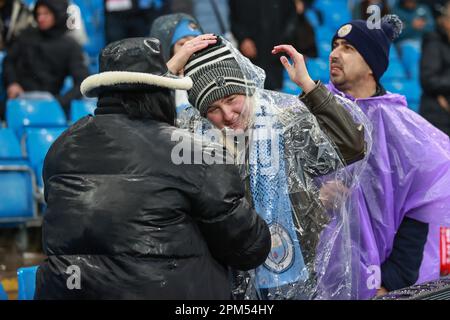 Manchester, UK. 11th Apr, 2023. Manchester City fans put on their waterproofs as heavy rain falls ahead of the UEFA Champions League Quarter-Finals 1st Leg Manchester City vs Bayern Munich at Etihad Stadium, Manchester, United Kingdom, 11th April 2023 (Photo by Mark Cosgrove/News Images) in Manchester, United Kingdom on 4/11/2023. (Photo by Mark Cosgrove/News Images/Sipa USA) Credit: Sipa USA/Alamy Live News Stock Photo