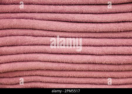 Stack of terry towels, selective focus. Soft background, pink bath textile close up Stock Photo