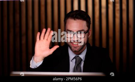 Young handsome businessman goodbye to the client and waves his hand. Stock Photo