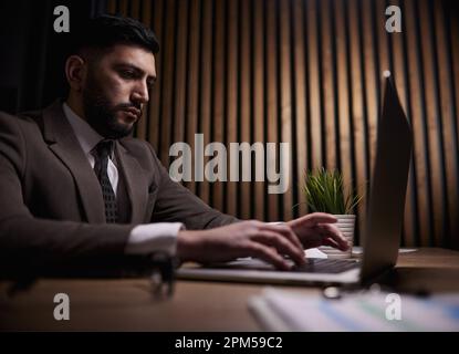 Man working on a laptop in the office Stock Photo
