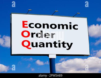 EOQ economic order quantity symbol. Concept words EOQ economic order quantity on big white billboard against beautiful blue sky background. Business E Stock Photo