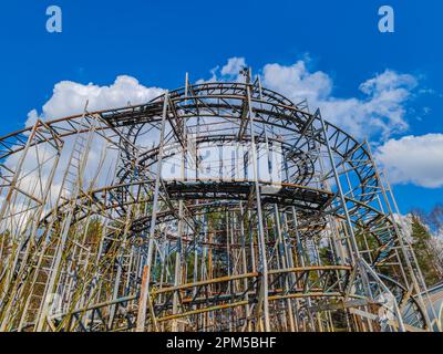 Abandoned rollercoaster in a park in middle of the city. Amusement