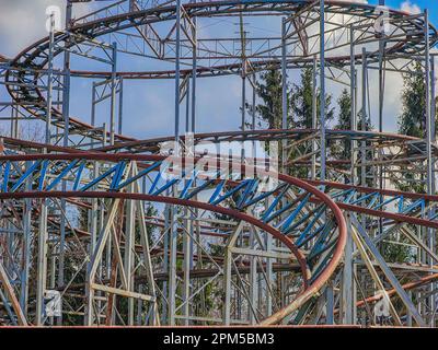 Abandoned rollercoaster in a park in middle of the city. Amusement