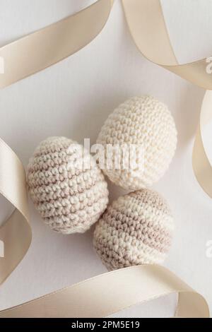 Set of cute handmade crocheted eggs, pastel color, striped pattern Stock Photo