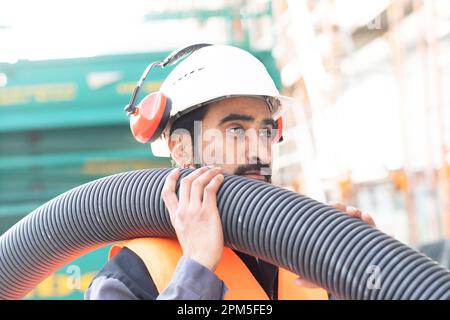 young technician safety glasses and helmet working Stock Photo