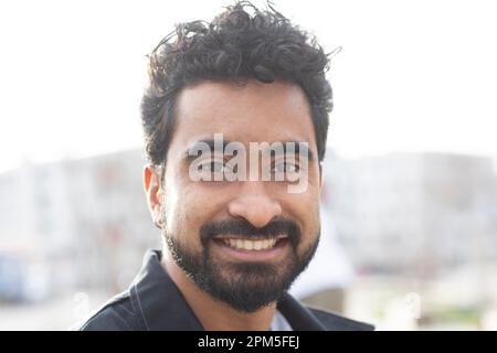 portrait of a young man with short hair outside Stock Photo