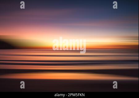 Abstract blurred seascape of colorful sunset over the ocean. Stock Photo