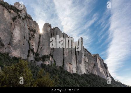 Sun sets behind cliffs of Montserrat in Spain Stock Photo