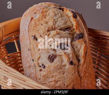 Wicker bread basket with freshly baked loaf on white marble table in ...