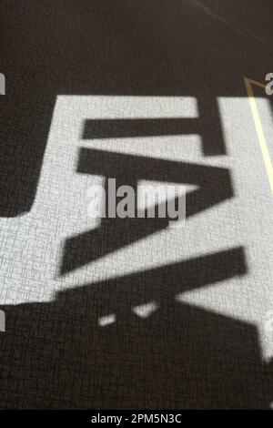 Abstract view of shadows of letters projected on the carpet floor. Stock Photo