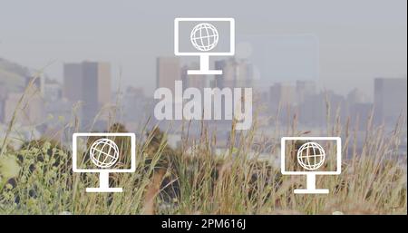 Image of network of screen icons with globes and envelopes over cityscape Stock Photo