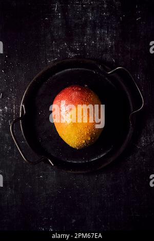 Fresh Mango on black tray and black background Stock Photo