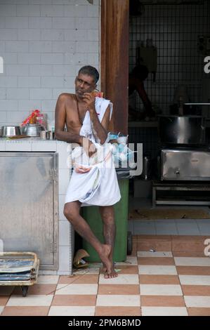 Cook having a rest outside kitchen at Deepavali ceremony, Sri Veeramakaliamman Temple, Little India, Singapore Stock Photo