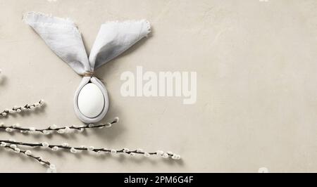 Easter Bunny Ears, eggs and spring willow branches top view flat lay. Minimal styled Easter card concept Stock Photo