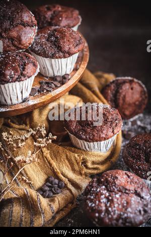 Homemade chocolate muffins with cholcolate chips in a rustic kitchen Stock Photo