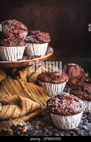 Homemade chocolate muffins with cholcolate chips in a rustic kitchen Stock Photo
