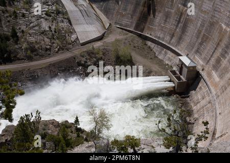 Spring runoff water jets from the two 72 inch outlets at the bottom of 199 foot-tall Gibson Dam.  The outlets have a capacity of 3,050 CFM. Stock Photo