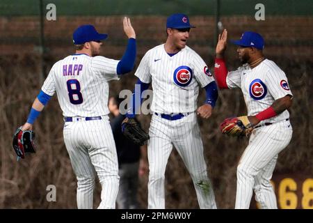 Chicago Cubs third baseman David Bote (13), shortstop Zach McKinstry (6)  and right fielder Nelson Velazquez celebrate the team's 2-1 win in a  baseball game against the Miami Marlins, Tuesday, Sept. 20