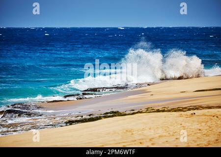 Ocean waves breaking onto a sand beach Stock Photo