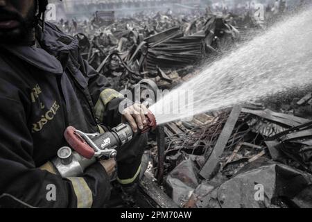 Dhaka, Bangladesh. 5th Apr, 2023. The fire of Bangabazar has not been extinguished even in two days. All money and clothes have been burnt to ashes. On one side the fire service people are putting out the fire, on the other side the shopkeepers are looking for the last parts from all the burnt shops.On April 4, 2023, a massive fire broke out at Bangabazar Market, a popular clothing market in Dhaka, Bangladesh. (Credit Image: © Jubair Ahmed Arnob/Pacific Press via ZUMA Press Wire) EDITORIAL USAGE ONLY! Not for Commercial USAGE! Stock Photo