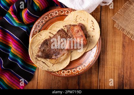 Roast meat (carne asada) very popular dish in northern Mexico, also called Asado, Discada or Parrillada, is a cooking technique in which food is expos Stock Photo