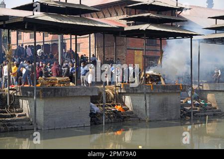 Discreet view of two cremation sites in Pashupatinath (Kathmandu), seen from the opposite side of the river Bagmati Stock Photo
