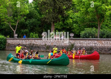 Young people practicing canoeing on rio Tajo river or Tagus river in the La Isla garden Aranjuez Spain.  The Tagus begins its journey through the plai Stock Photo