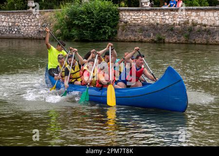 Young people practicing canoeing on rio Tajo river or Tagus river in the La Isla garden Aranjuez Spain.  The Tagus begins its journey through the plai Stock Photo