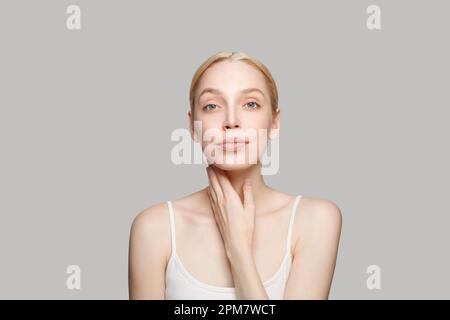 Portrait of pretty cheerful woman with clear skin, studio headshot photo. Facial treatment, skincare and cosmetology concept Stock Photo