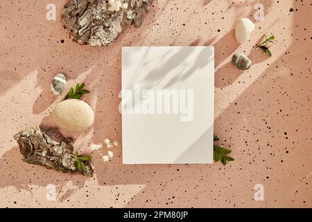 Sustainable, zero waste, recycling lifestyle with stationery card mock up with tree bark, green leaves, pebbles with hard shadows. Copy space. Stock Photo
