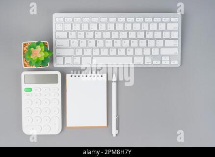Workspace desk with open blank notebook and calculator with computer keyboard for creative flat lay concept Stock Photo
