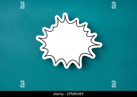 White speech bubble shaped post it note on green background with copy space. Stock Photo