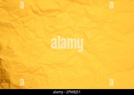 Abstract background from crumpled yellow paper texture. Stock Photo