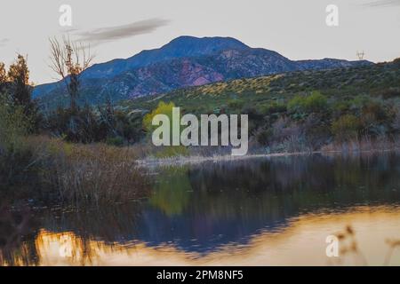 Discover the rugged beauty of Lone Pine Canyon with this stunning image of a hilltop viewed from Lost Lake, a sag pond formed by the San Andreas Fault. Stock Photo