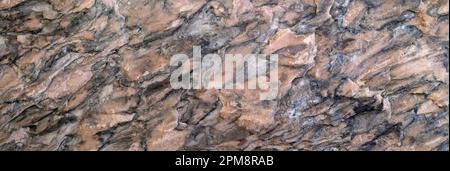 Abstract pattern in brown, gray and black in a rough stone surface Stock Photo