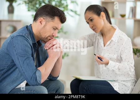 young woman supporting depressed frustrated husband Stock Photo