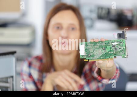 yoemale digital electronic engineer testing computer pc motherboard Stock Photo
