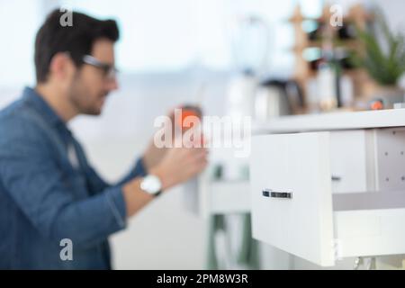 carpenter working on new kitchen cabinets Stock Photo