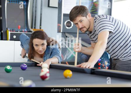 fashionable snooker players holding beer mugs Stock Photo