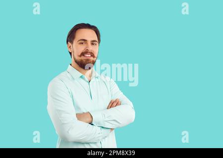 Portrait of young confident and stylish millennial hipster man on vivid light blue background. Stock Photo