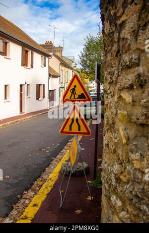 Under Construction Board Sign on the Closed Road with Arrow Sign and Traffic Cone. Caution Symbol Under Construction, Work in Progress Sign. Stock Photo