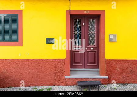 Brightly painted wall and old door, Funchal, Madeira Stock Photo