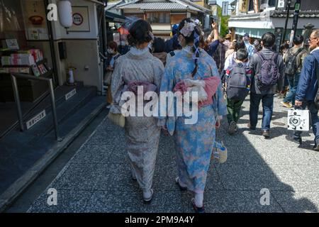 Kyoto, Japan - March 28, 2023: Women dressed in kimonos walk on Sannenzaka, a cobbled pedestrian street in Kyoto, Japan. Stock Photo