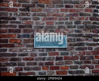 Information sign on the old bricks of North Bar, the only surviving gatehouse in Beverley, East Riding, Yorkshire, UK Stock Photo