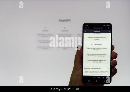 ChatGTP with hand holding mobile with bot screen, inputting question what is OpeanAI model based on Generative Pretrained Transformer  Architecture Stock Photo