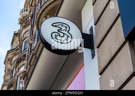 London. UK- 04.09.2023. The name sign of a retail branch of Three on Oxford Street. A British national mobile network and internet service provider. Stock Photo
