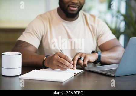 Young business black african american man working from home on table with notebook computer laptop Stock Photo